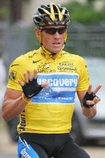 
Lance Armstrong counts off the number of his Tour de France titles on Sunday.
 (Associated Press / The Spokesman-Review)