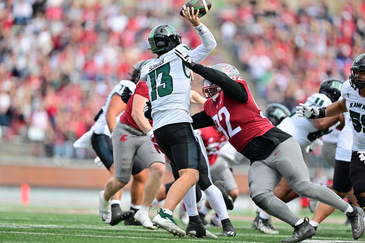 Washington State’s Ansel Din-Mbuh puts pressure on Hawaii’s Brayden Schager on Saturday at Gesa Field in Pullman.  (Tyler Tjomsland/The Spokesman-Review)