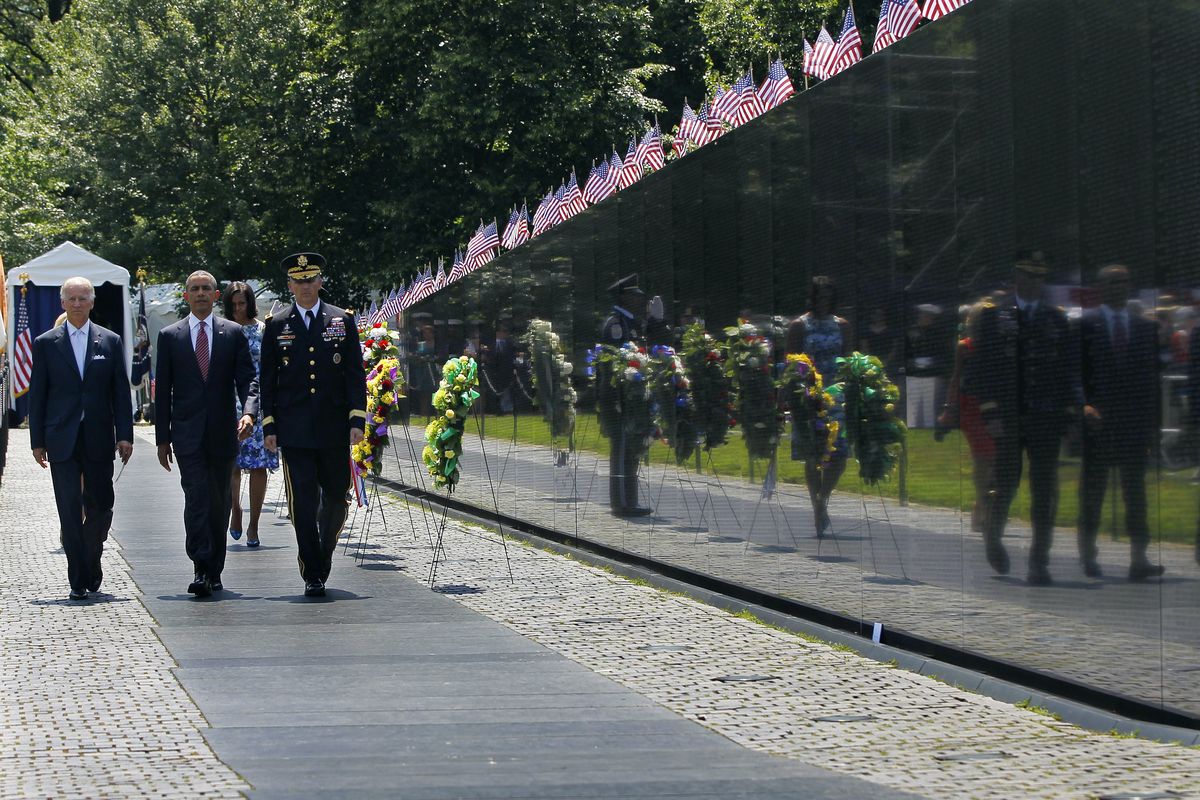 President Barack Obama, center, Vice President Joe Biden and Maj. Gen. Michael S. Linnington, commander of the U.S. Army Military District of Washington walk past the Vietnam Veterans Memorial Wall on Monday. (Associated Press)