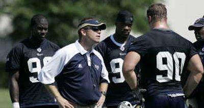 
St. Louis coach Scott Linehan talks with Rams rookie first-round draft pick Adam Carriker (90), as James Hall, left, and Leonard Little listen in. Associated Press
 (Associated Press / The Spokesman-Review)