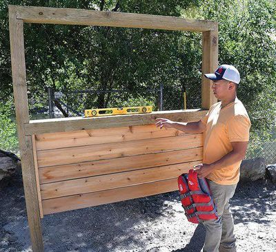 Sam Hoggatt of the Idaho Parks and Recreation Department shows the new loaner life jacket station at Riggins, one of more than 100 around the state. (Barry Kough / Lewiston Tribune)