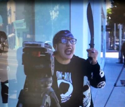 In this Thursday, Sept. 21, 2017, video image released by the Los Angeles County Sheriff's Department, a woman  waves a machete at news reporters outside the Kardashian-owned DASH boutique in West Hollywood, Calif. (Associated Press)