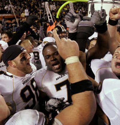 
Missouri players celebrate last week's 36-28 victory over Kansas. They go for the Big 12 title today. Associated Press
 (Associated Press / The Spokesman-Review)