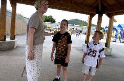 
Art teacher Jane Morgan, left, chats with Brock Baughman, 9, and Jacob Rucker, 7, right, under the new playground shelter at Borah Elementary School. The students have conceived and designed various elements of the playground as art projects. 
 (Jesse Tinsley / The Spokesman-Review)