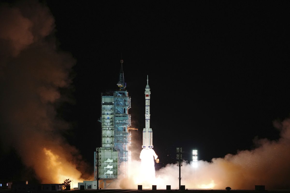 In this photo released by Xinhua News Agency, the crewed spaceship Shenzhou-13, atop a Long March-2F carrier rocket, is launched from the Jiuquan Satellite Launch Center in northwest China