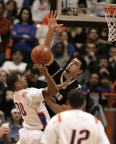 Idaho's Kyle Barone rejects Boise State's Westly Perryman in the first half Saturday night at Boise. (Associated Press)