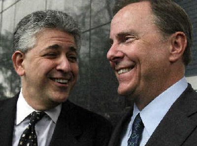 
Former Enron executive Jeffrey Skilling, right, and his attorney Daniel Petrocelli share a laugh outside the federal courthouse after the prosecution rested its case on Tuesday. 
 (Associated Press / The Spokesman-Review)