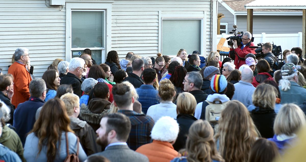 Well over 100 people crowd into the playground area at Spokane’s Martin Luther King Jr. Family Outreach Center  after racist graffiti was discovered there Tuesday morning. (Jesse Tinsley / The Spokesman-Review)