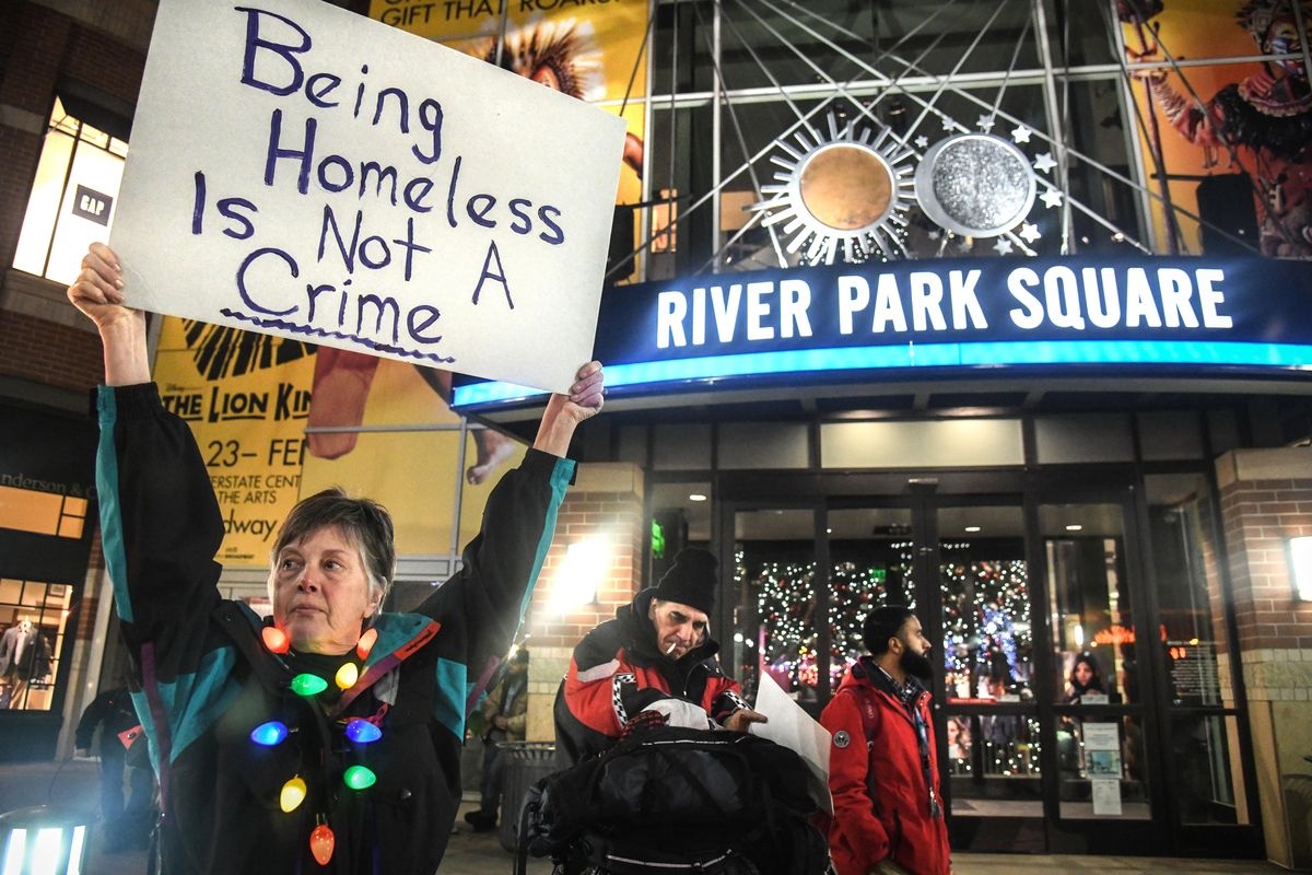 Deb Maier holds a sign during a protest against the city’s policies toward the homeless population in December 2018. A recent broadcast news story suggesting Seattle is “dying” because of its issues surrounding visible, chronic homelessness has prompted a strong political reaction in Spokane. (Dan Pelle / The Spokesman-Review)