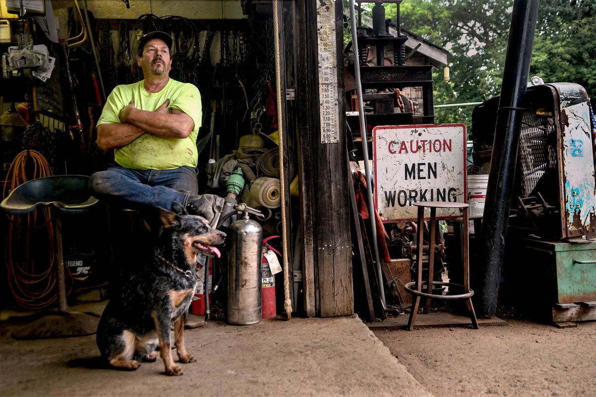 Rathdrum Prairie farmer Laurin Scarcello talks on Aug. 5 about the explosion of growth in the area and the legacy of his family farm next to his dog Scooter.  (kathy plonka)