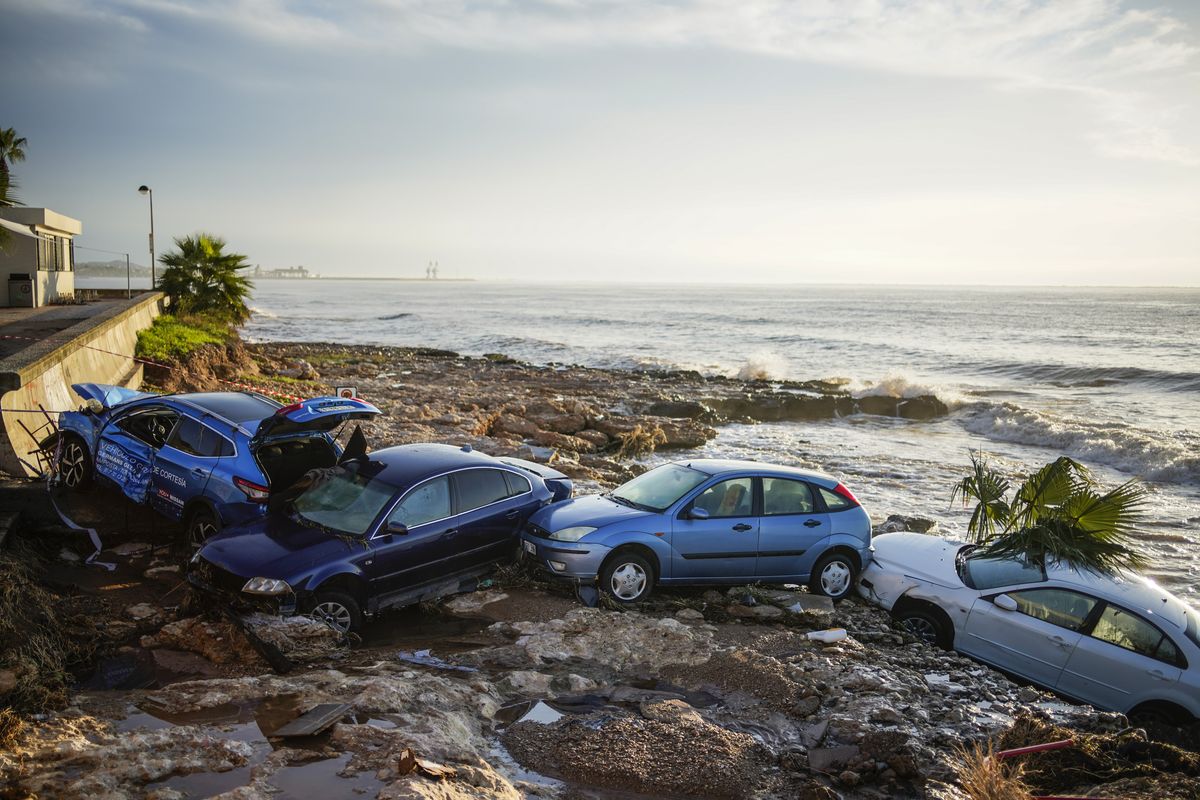 Wrecked cars stuck in the shore of the seaside town of Alcanar, in northeastern Spain, Thursday, Sept. 2, 2021. A downpour Wednesday created flash floods that swept cars down streets in the Catalan town of Alcanar. Most of mainland Spain is under alert for heavy rains.  (Joan Mateu Parra)