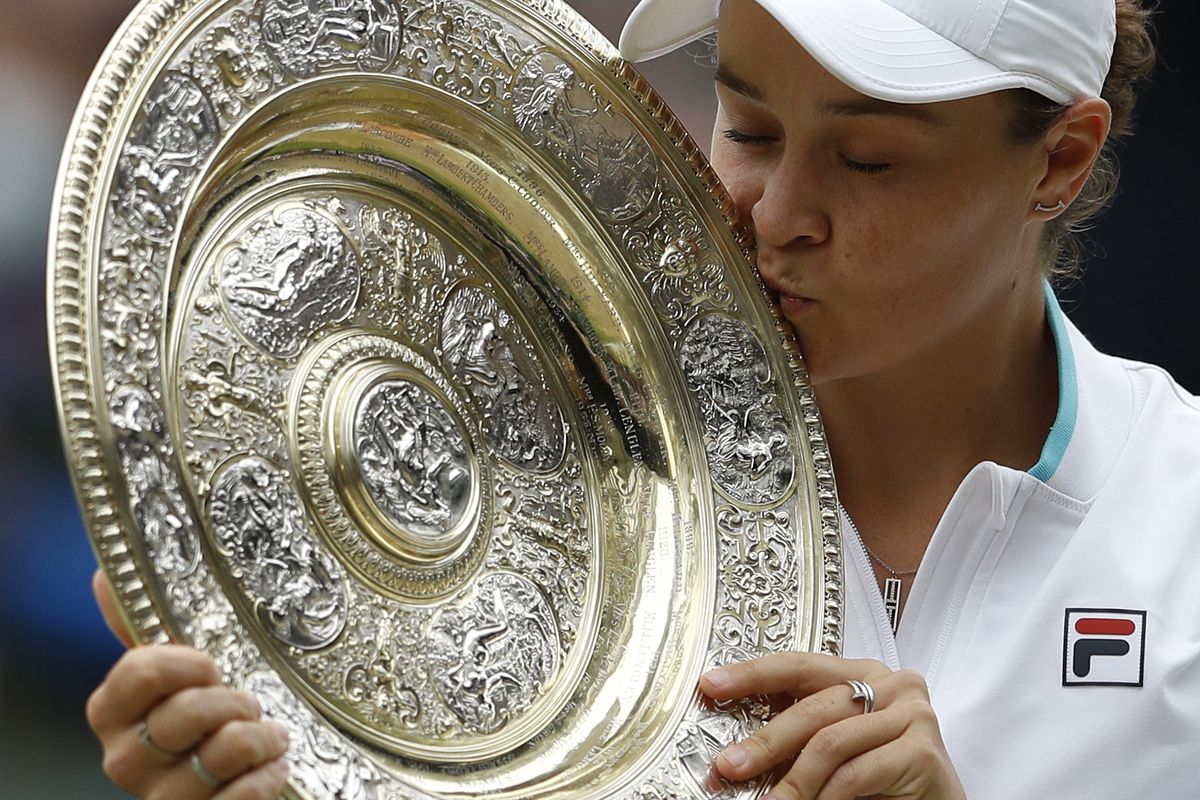 Australia's Ashleigh Barty poses with the winners trophy for the media after winning the women's singles final defeating the Czech Republic's Karolina Pliskova on day twelve of the Wimbledon Tennis Championships in London, Saturday, July 10, 2021.  (Pete Nichols)