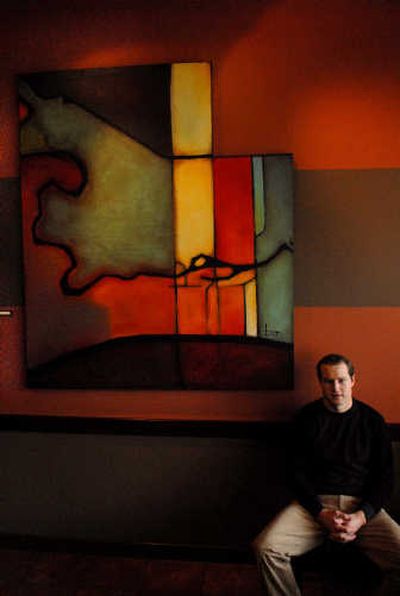 
Spokane artist Ben Joyce with one of several paintings on display at the Downriver Grill in Spokane. 
 (Brian Plonka / The Spokesman-Review)