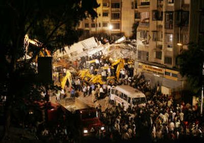 
Rescue workers remove debris from the site of a collapsed seven-story building in  Mumbai, India. Associated Press
 (Associated Press / The Spokesman-Review)