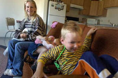 
Tasha Lantto watches her son, Grant Hiebert, while her daughter, Raynie Lantto, giggles on their couch. The family was the first to move into a Salvation Army housing complex.
 (Christopher Anderson/ / The Spokesman-Review)