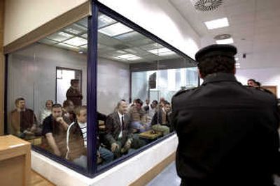 
A police officer stands in front of a glass cage holding the Madrid train bomb suspects Wednesday at the national court in Madrid. After nearly five months of testimony, a  panel convicted 21 men. Associated Press
 (Associated Press / The Spokesman-Review)