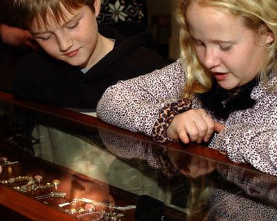 
 Shoppers Nic Johnson, 10, and McKaylin Shirey, 11, look at the goods in Austin's Fine Jewelry case at the bazaar put on by the Spokane County Domestic Violence Consortium on Sunday. 
 (Liz Kishimoto / The Spokesman-Review)