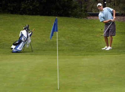 
Central Valley junior Nick Grigsby, chipping onto the par-3 13th hole at Indian Canyon Golf Course, won the State 4A boys golf title Friday with a birdie on the final hole. 
 (Jed Conklin / The Spokesman-Review)