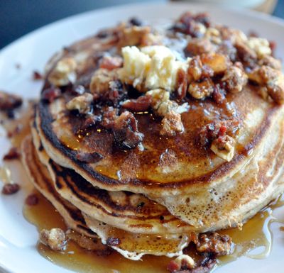 Three whole-wheat pancakes topped with bacon, bourbon-butter, maple syrup and candied walnuts go for $9 at Bruncheonette. (Adriana Janovich/THE SPOKESMAN-REVIEW)
