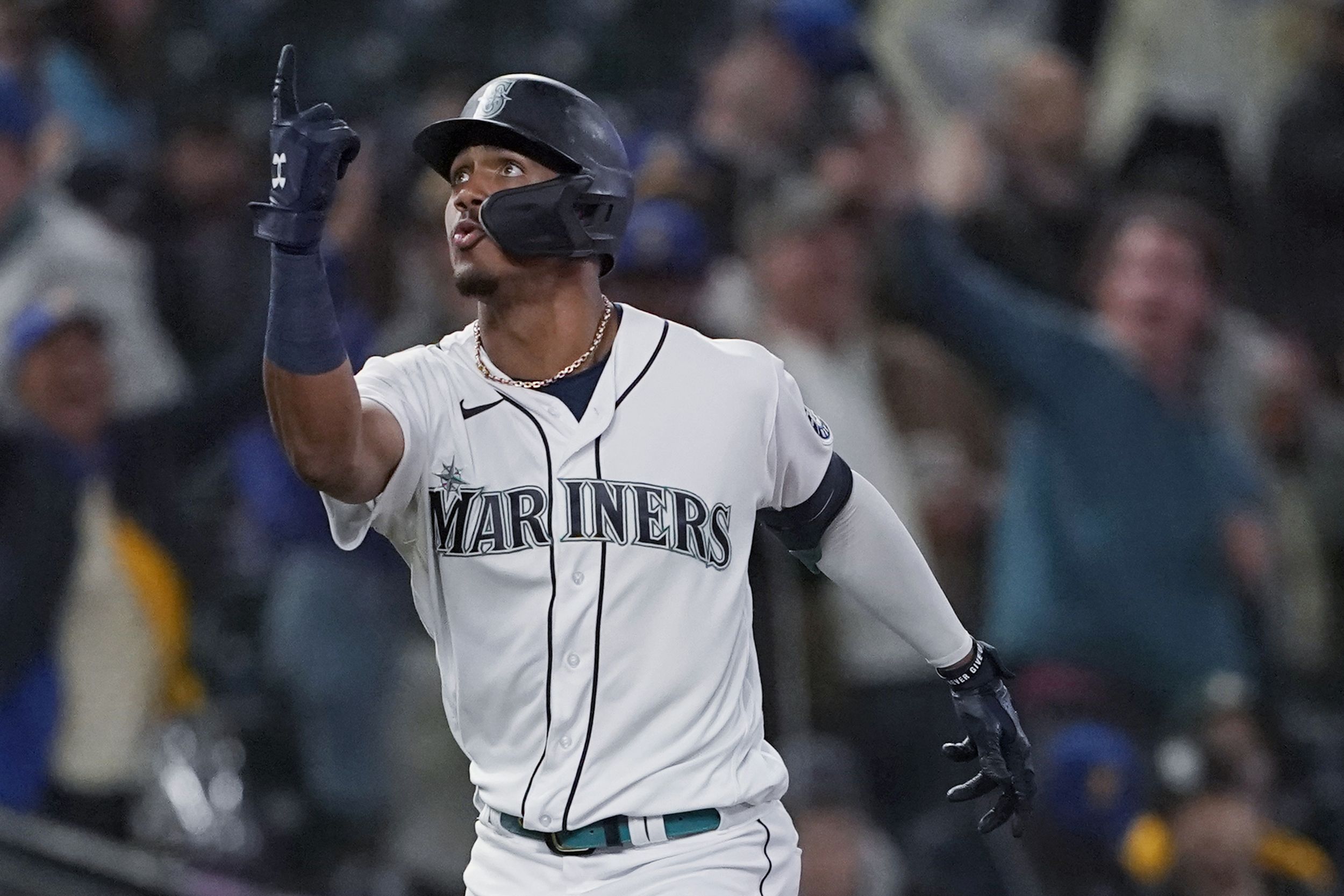 Seattle Mariners' Julio Rodriguez smiles while standing next to