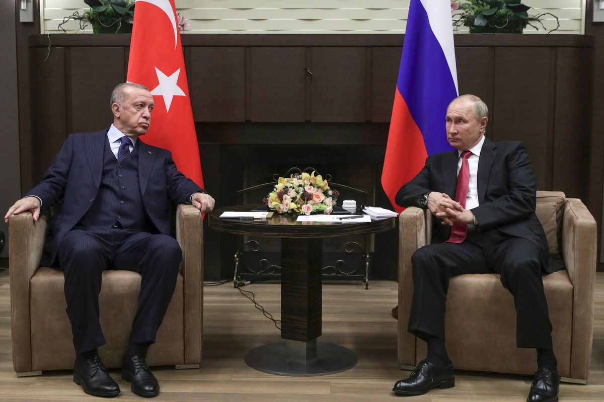 In this Sept. 29, 2021 photo, Russian President Vladimir Putin, right, and Turkish President Recep Tayyip Erdogan talk to each other during their meeting in the Bocharov Ruchei residence in the Black Sea resort of Sochi, Russia. In Russia, it