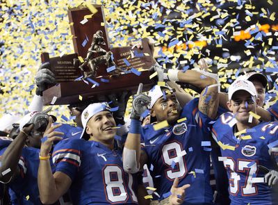 Florida players celebrate after receiving the SEC Championship trophy and a likely berth in next month’s BCS championship game.  (Associated Press / The Spokesman-Review)