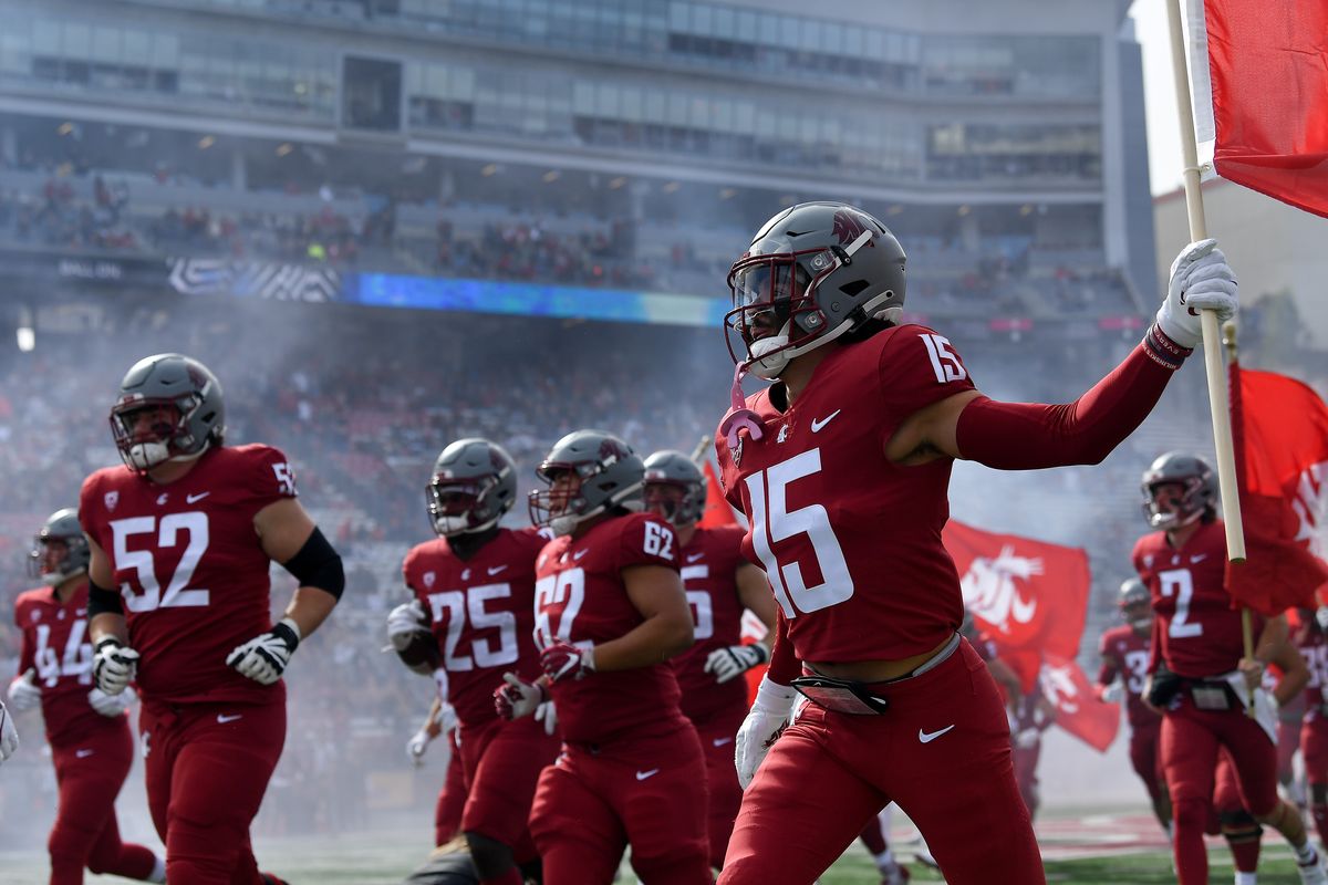 WSU wide receiver Mitchell Quinn (15) takes to the field with his teammates before a game on Saturday at Gesa Field in Pullman.  (Tyler Tjomsland/The Spokesman-Review)