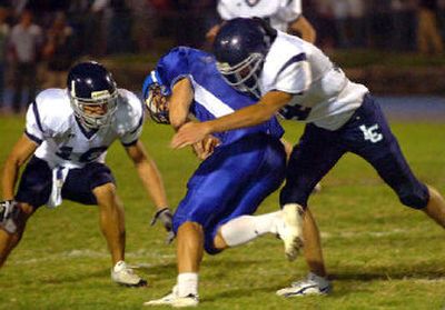 
Chris Bobbitt, right, and Garren Hammons, left, wrap up Coeur d'Alene QB Shea Vucinich. Bobbitt is part of a strong linebacking corps. 
 (Jesse Tinsley / The Spokesman-Review)
