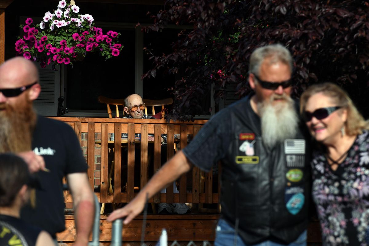 WWII Navy Veteran Ron Hemming watches as members of the Combat Vet Riders gather in front of his home in Spokane Valley to celebrate his 104th birthday on Thursday, May 28, 2020. (Kathy Plonka / The Spokesman-Review)