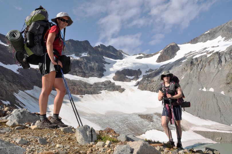 Holly Weiler, left, and Samantha Journot of the Spokane Mountaineers climb past Lyman Glacier as they head toward Spider Gap to complete their loop backpacking trek in the Glacier Peak Wilderness. (Rich Landers)
