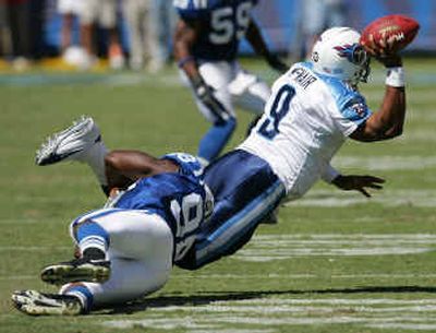 
Titans quarterback Steve McNair (9) gets rid of the ball while being tackled by Colts defensive end Robert Mathis on Sunday. 
 (Associated Press / The Spokesman-Review)