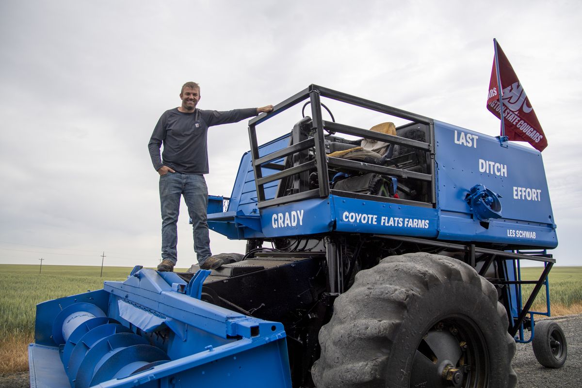 Grady Gfeller stands on his 2023 entry into the annual Lind Combine Derby in Lind, Wash., on Thursday. On Saturday, Gfeller will put his 1979 John Deere 6602 combine in the Lions Club combine demolition derby to try his hand.  (James Snook/For The Spokesman-Review)