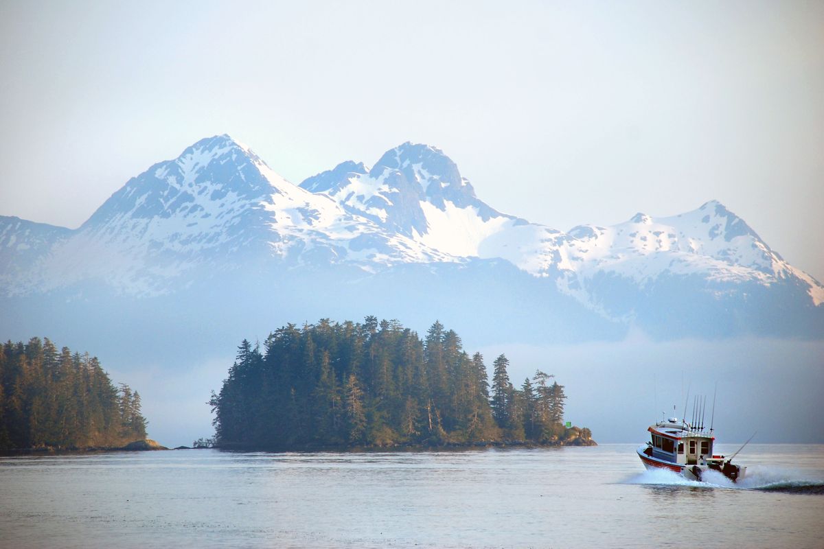 A southeast Alaska charterboat heads out through the islands before sunrise from the harbor in Sitka, Alaska, to the ocean to fish for salmon. (Rich Landers)