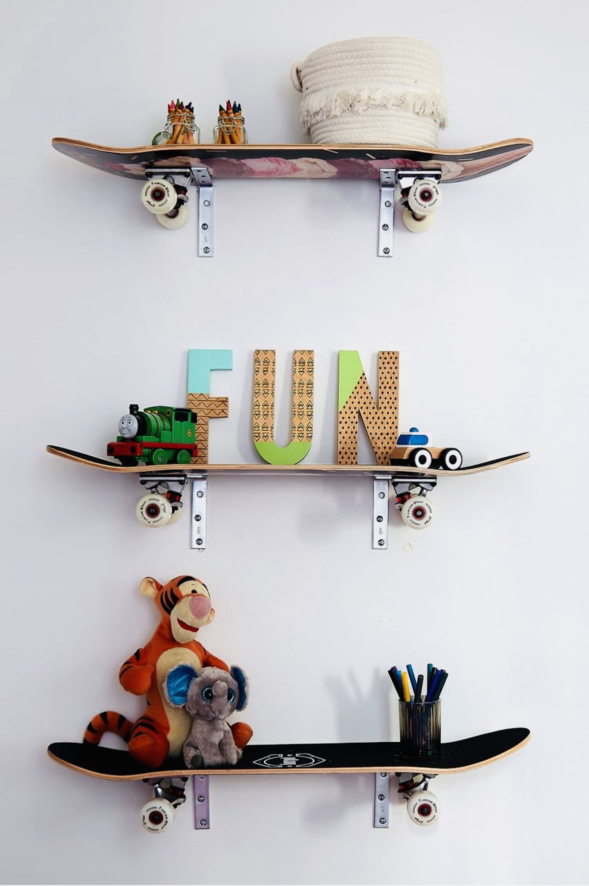 This display uses skateboards as decorative shelves in a children’s bedroom. (Tribune News Service)