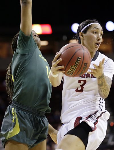 Washington State's Lia Galdeira turns to pass after driving the lane against Oregon's Jillian Alleyne during the Pac-12 women's basketball tournament Thursday. (Associated Press)