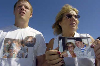 
Brian and Kay McGlocklin are hoping for a complete recovery of their friend Austin Askins after he was shot in the face Monday in Boise. The attack is believed to be unprovoked. The photograph Kay holds of herself and Askins was taken June 8. 
 (Dan Pelle / The Spokesman-Review)
