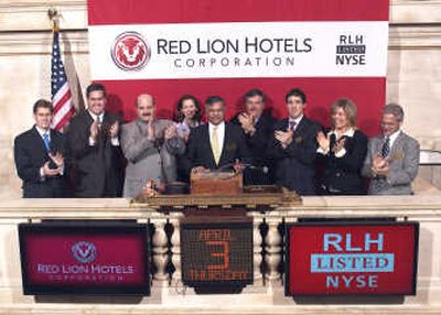 
Red Lion Hotels Corp.'s president and chief executive officer, Anupam Narayan, of Spokane, center, stands with Noreen Culnane, executive vice president of the New York Stock Exchange, to his right, and Narayan's fellow Red Lion executives at the closing bell of the NYSE on Thursday. Spokane-based Red Lion was celebrating the 10th anniversary of its listing on the exchange. Courtesy of Red Lion Hotels Corp.
 (Courtesy of Red Lion Hotels Corp. / The Spokesman-Review)