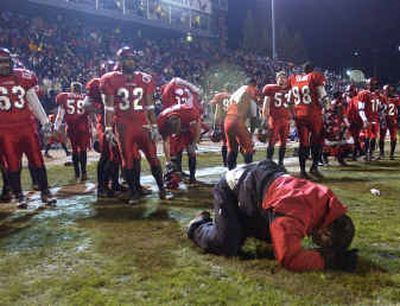 
EWU assistant coach Keith Murphy drops to his knees as the Eagles lose Saturday's game to Sam Houston State in Cheney. Leading for most of the game, the Eagles were unable to hold off the Bearkats, who went the length of the field with no timeouts to score in the final two seconds.
 (Christopher Anderson/ / The Spokesman-Review)