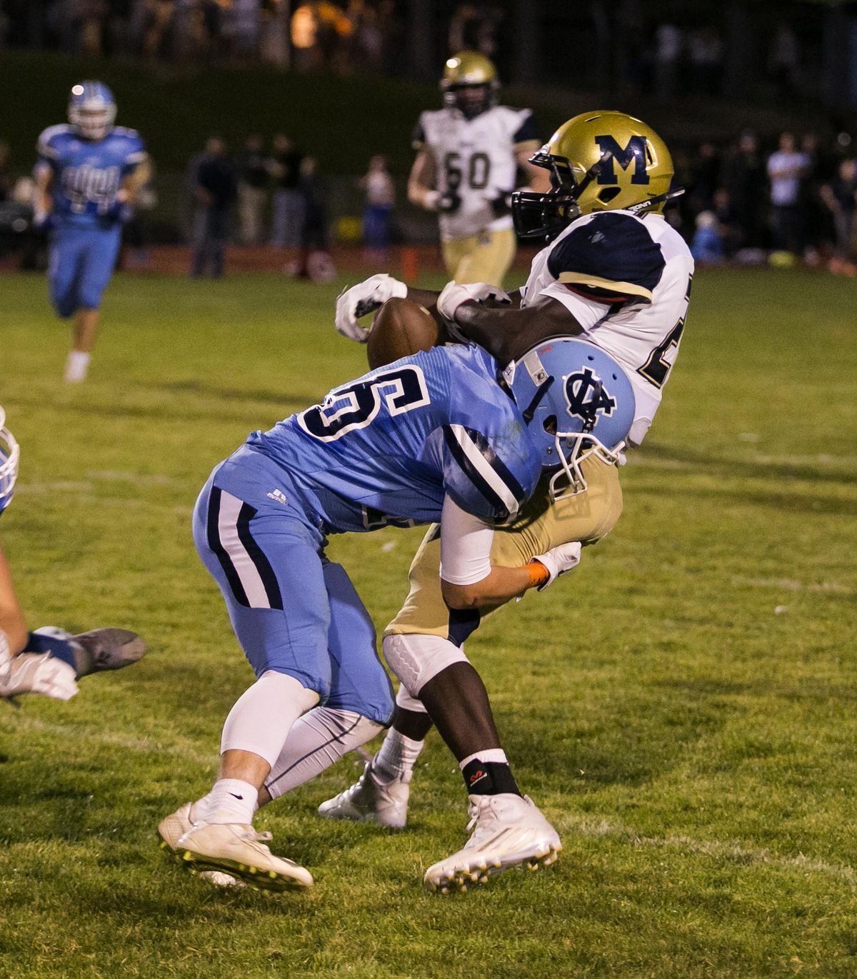 Central Valley’s Brayden Hamilton hits Mead’s EJ Bade to force a fumble during the second quarter Friday night at Central Valley High School. (BRUCE TWITCHELL / Special to The Spokesman-Review)