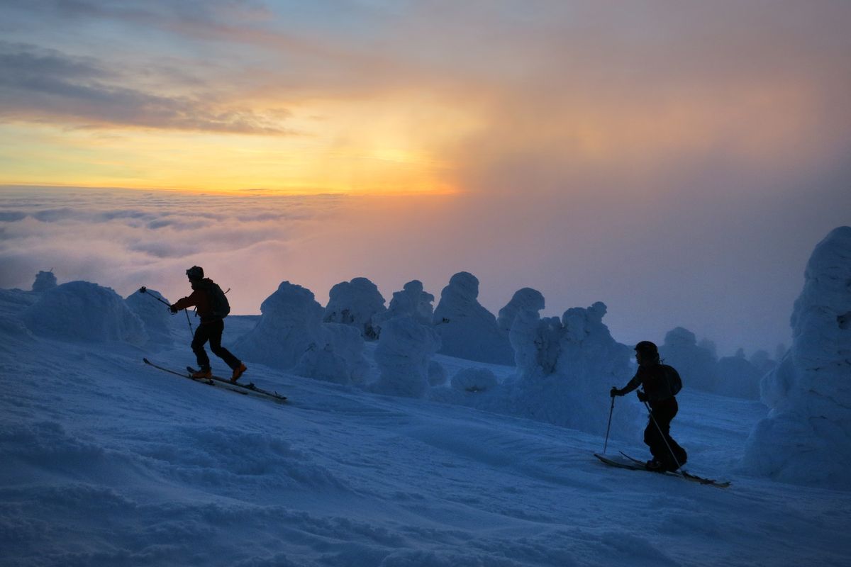 Jeff Zickler and Daniel Henry ascend to the summit of Mount Spokane for a pre-dawn workout, before resort lifts open, followed by a fast ski and splitboard descent. (Travis Nichols)