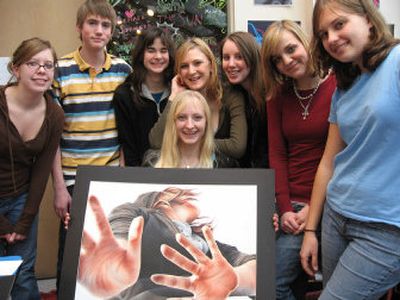 East Valley High School student Christine Strong, front, holds her pastel drawing,