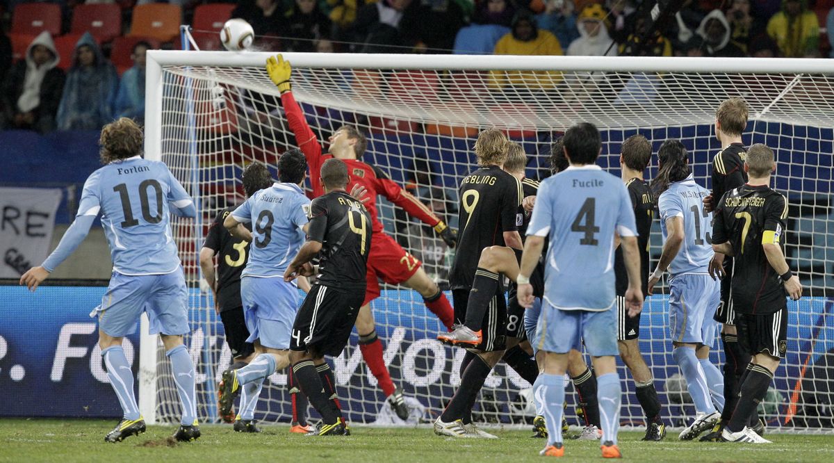 A ball by Uruguay's Diego Forlan, left, hits the bar on the final play of the third-place match, giving Germany the victory.  (Associated Press)