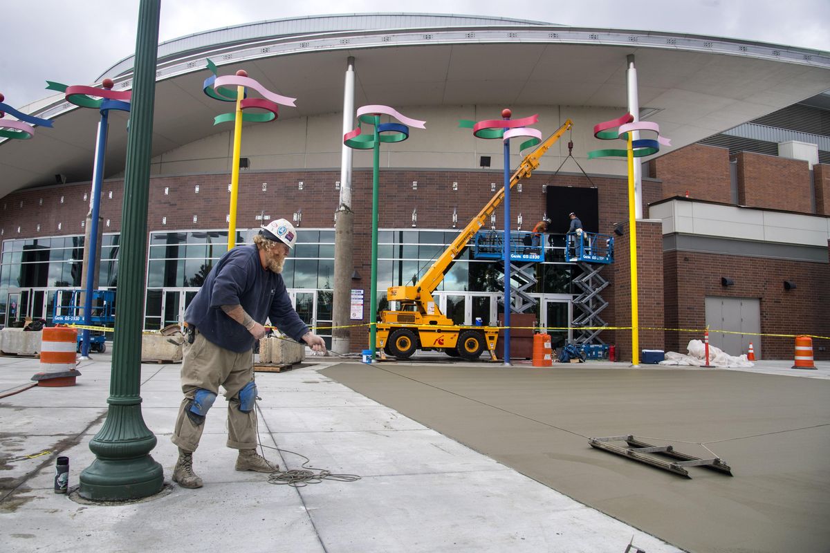 Donald Wigen, Jr., of Garco Construction, does concrete finish work outside the Spokane Arena’s main entrance on Sept. 20. (Dan Pelle / The Spokesman-Review)