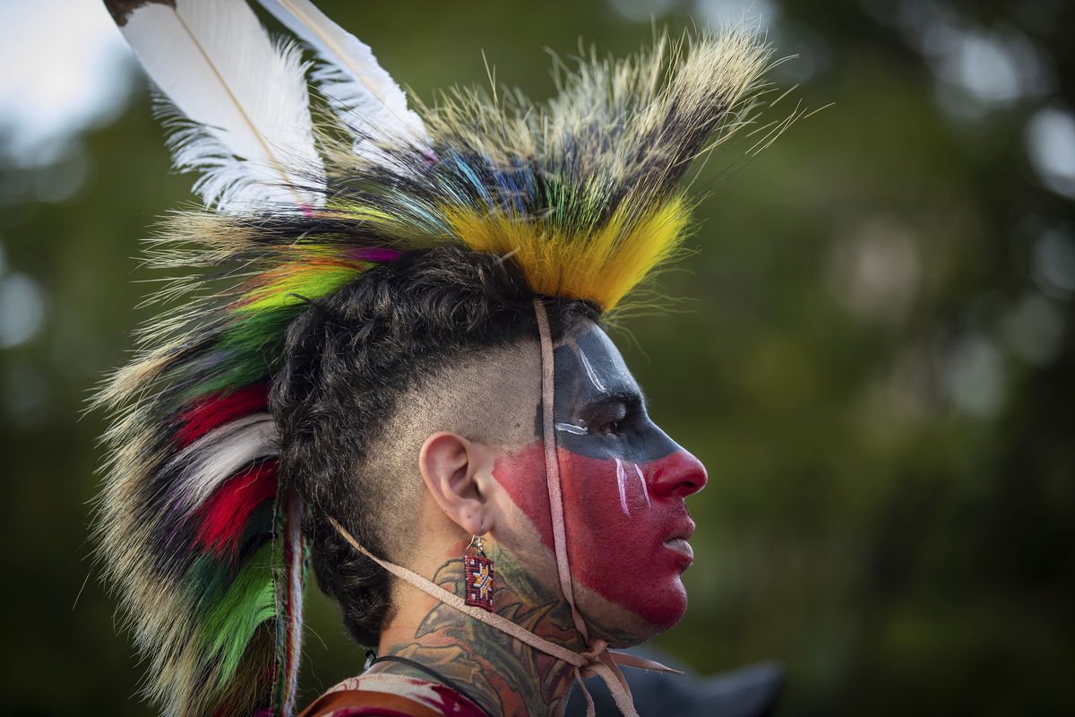 Zachary Orchard, of the Shoal Lake 40 First Nation on the Manitoba and Ontario border, listens during a ceremony and vigil for the 215 children whose remains were found buried at the former Kamloops Indian Residential School, in Vancouver, British Columbia, on National Indigenous Peoples Day, Monday, June 21, 2021.  (Darryl Dyck)