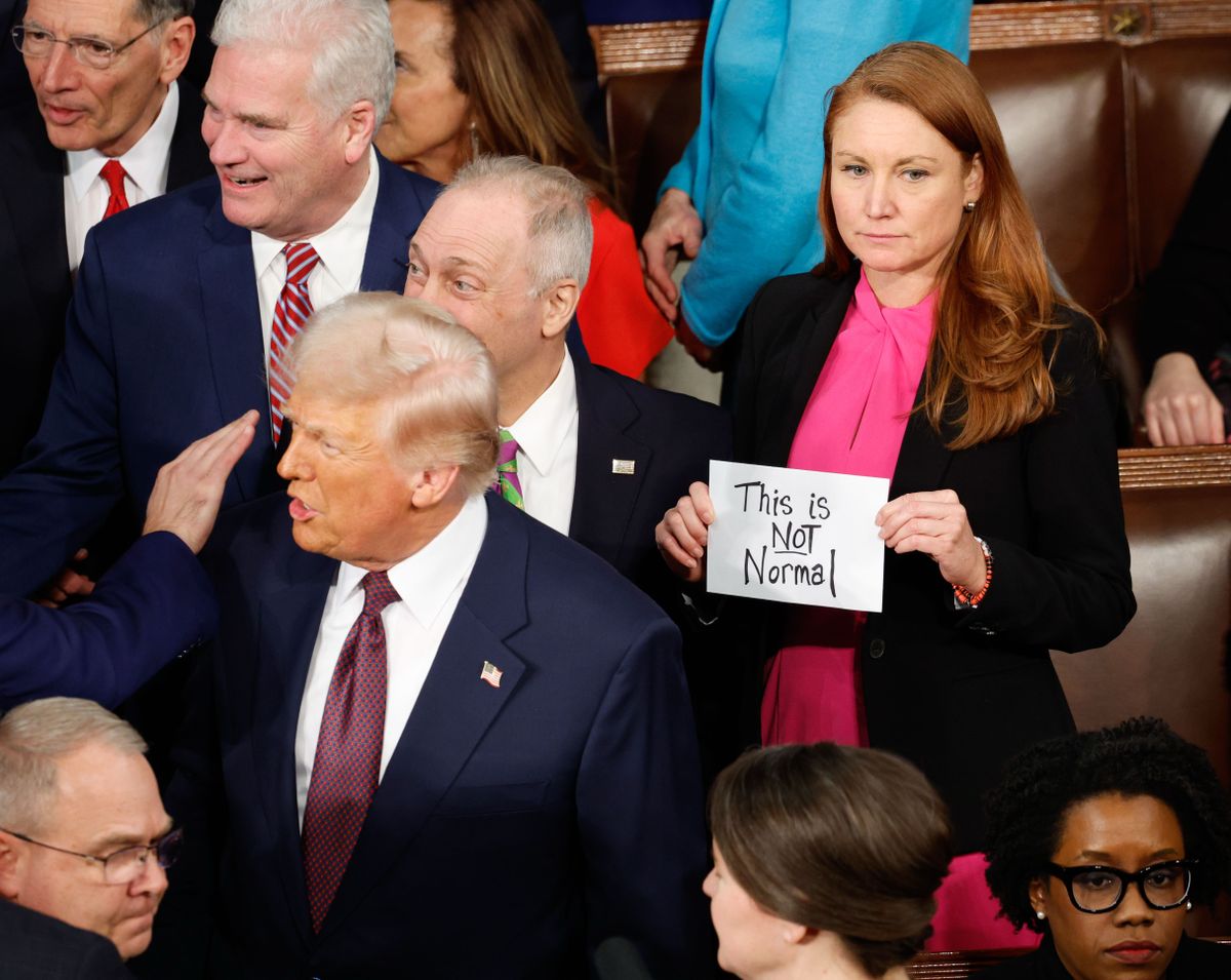 Rep. Melanie Stansbury (D-New Mexico) holds a protest sign as President Donald Trump arrives to address a joint session of Congress on March 4. MUST CREDIT: Tom Brenner/For The Washington Post  (Tom Brenner/For The Washington Post)