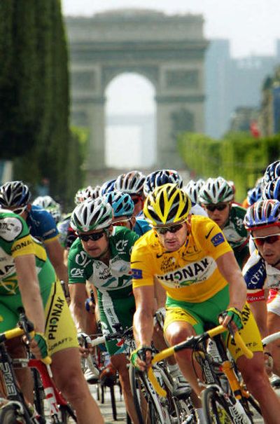 
Floyd Landis, center, pedals on his way to winning the 93rd Tour de France in Paris on Sunday. 
 (Associated Press / The Spokesman-Review)