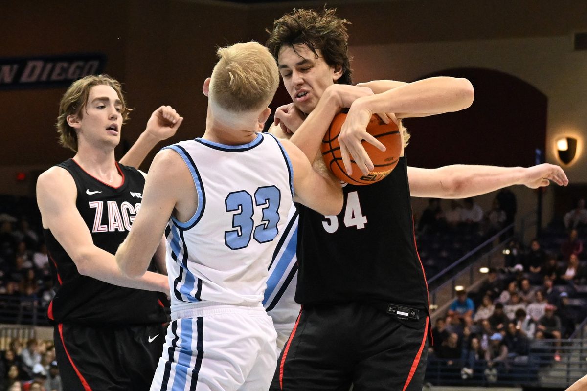 Gonzaga Bulldogs forward Braden Huff (34) battles for a rebound against San Diego Toreros guard Dominic Muncey (33) during the second half of a college basketball game on Saturday, Jan. 20, 2024, at Jenny Craig Pavilion in San Diego, Calif. Gonzaga won the game 105-63.  (Tyler Tjomsland/The Spokesman-Review)