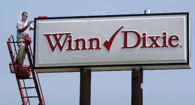 A sign with the new Winn-Dixie logo goes up Thursday Winn-Dixie headquarters, in Jacksonville, Fla. 
 (Associated Press / The Spokesman-Review)