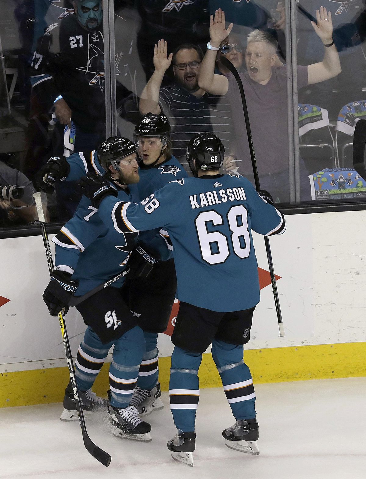 San Jose Sharks left wing Marcus Sorensen, center, is congratulated by defenseman Paul Martin (7) and right wing Melker Karlsson (68), from Sweden, after scoring a goal against the Anaheim Ducks during the first period of Game 4 of an NHL hockey first-round playoff series in San Jose, Calif., Wednesday, April 18, 2018. (Jeff Chiu / Associated Press)