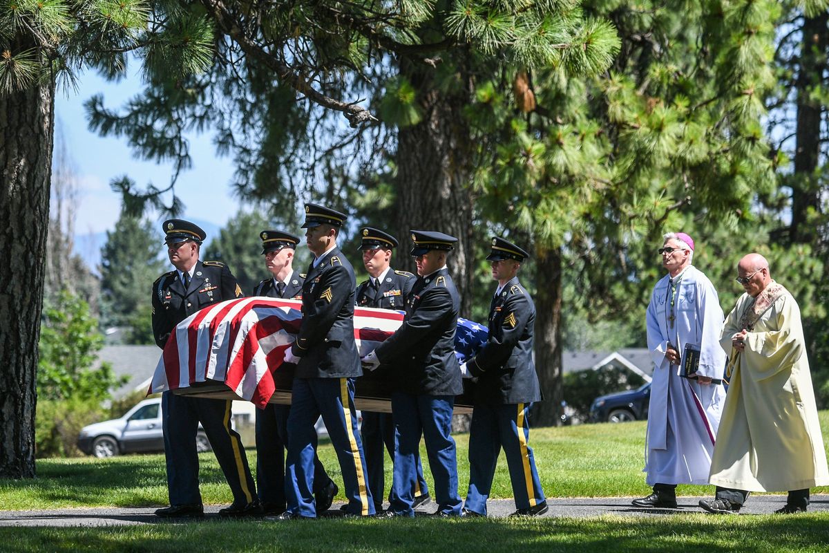 U.S. Army Air Forces 2nd Lt. Eugene P. Shauvin is carried to his final resting place in Holy Cross Cemetery by members of the Washington State National Guard Honor Guard on Saturday.  (Dan Pelle/The Spokesman-Review)